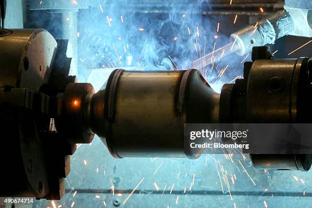 An automobile catalytic converter emission control device turns on a welding machine at BM Catalysts in Mansfield, U.K., on Wednesday, Sept. 30,...