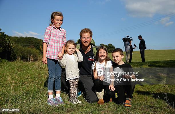 Prince Harry meets some children as he walks the route to Ludlow with Walking with the Wounded's Walk of Britain team on September 30, 2015 in...