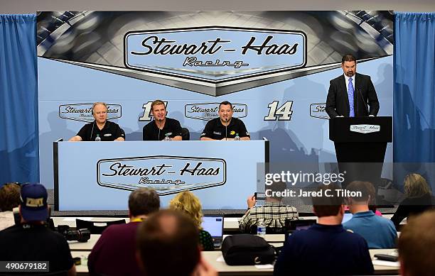 Clint Bowyer speaks with the media as Gene Haas, co-owner of Stewart-Haas Racing, Tony Stewart, driver of the Stewart-Haas Racing Chevrolet, and Mike...