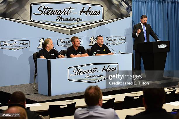 Clint Bowyer speaks with the media as Gene Haas, co-owner of Stewart-Haas Racing, Tony Stewart, driver of the Stewart-Haas Racing Chevrolet, and Mike...