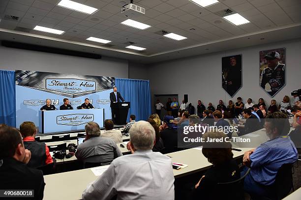 Tony Stewart, driver of the Stewart-Haas Racing Chevrolet and co-owner of Stewart-Haas Racing, speaks with the media as Gene Haas, co-owner of...