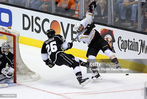 Slava Voynov of the Los Angeles Kings high sticks Mathieu Perreault of the Anaheim Ducks behind the net during third period of Game Six of the Second...