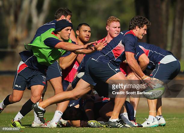 Luke Burgess of the Rebels passes the ball during a Melbourne Rebels Super Rugby training session at Marcellin College on May 15, 2014 in Melbourne,...