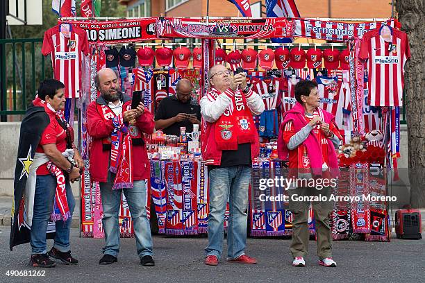 Benfica fans take selfies in front of a merchandaising stall at Vicente Calderon Stadium before the UEFA Champions League Group C match between Club...