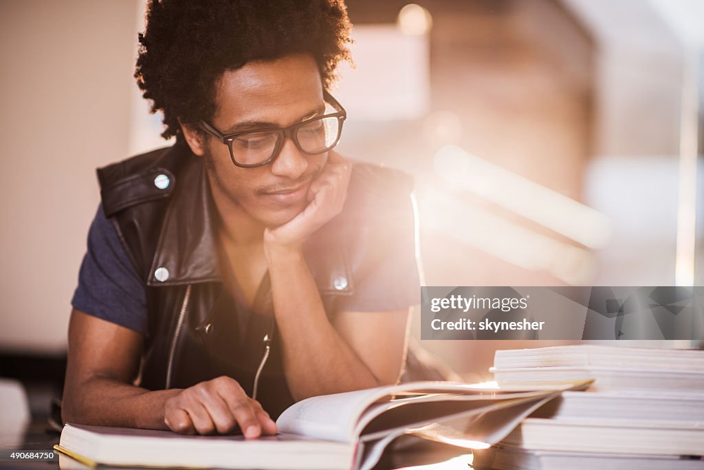 Smiling African American young man studying.