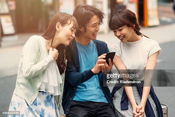 happy japanese friends surfing the net - crowd laughing stock pictures, royalty-free photos & images