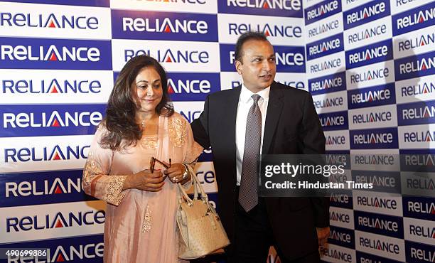 Anil Ambani, Chairman of Anil Dhirubhai Ambani Group, with wife Tina Ambani poses for the photographers before the 29th AGM of Reliance Anil...