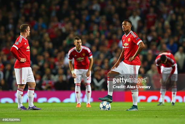 Wayne Rooney and Anthony Martial of Manchester United look dejected as Daniel Caligiuri of VfL Wolfsburg scores their first goal during the UEFA...