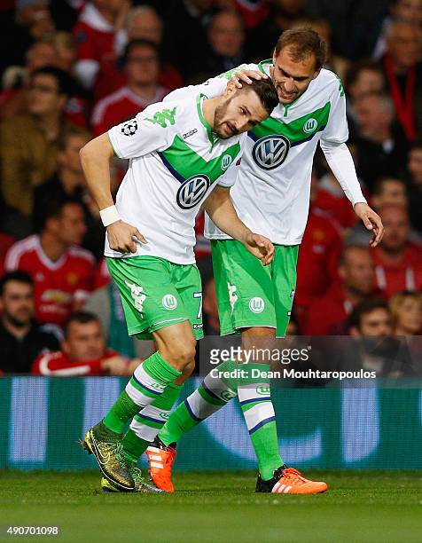 Daniel Caligiuri of VfL Wolfsburg celebrates with Bas Dost as he scores their first goal during the UEFA Champions League Group B match between...