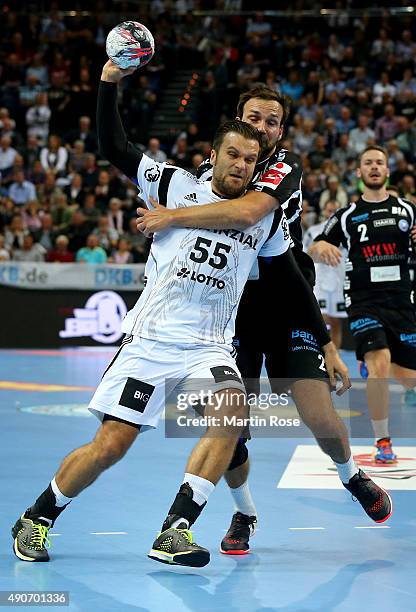 Dragos Oprea of Kiel challenges for the ball with Viktor Szilagyi of Bergischer HC during the DKB HBL Bundesliga match between THW Kiel and...