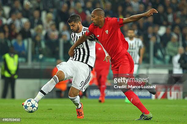 Alvaro Morata of Juventus FC competes for the ball with Steven N Zonzi of Sevilla FC during the UEFA Champions League group E match between Juventus...