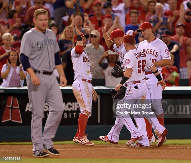 Johnny Giavotella, Mike Trout, Kole Calhoun and David Murphy of the Los Angeles Angels of Anaheim celebrate after Trout made a catch above the wall...