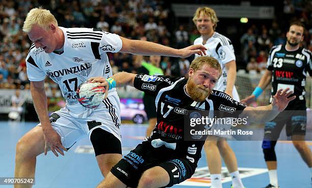 Patrick Wienczek of Kiel challenges for the ball with Jan Artmann of Bergischer HC during the DKB HBL Bundesliga match between THW Kiel and...