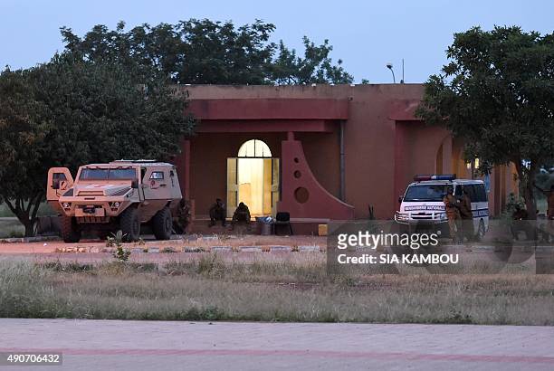 Soldiers of Burkina Faso's loyalist troops and of the Gendarmerie Nationale stand guard by the Naba Koom II barracks, the base of the Presidential...