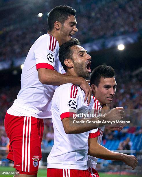 Nicolas Gaitan of SL Benfica celebrates scoring their opening goal with teammates Jonas Goncalves and Goncalo Guedes during the UEFA Champions League...