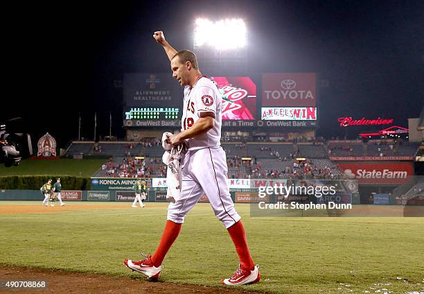 David Murphy of the Los Angeles Angels of Anaheim raises his fist to the crowd as he leaves to the field after his walk off RBI single in the ninth...