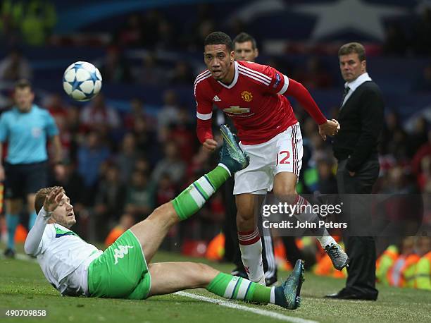 Chris Smalling of Manchester United in action with Nicklas Bendtner of Wolfsburg during the UEFA Champions League Group C match between Manchester...