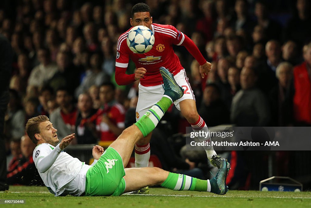 Nicklas Bendtner of VFL Wolfsburg and Chris Smalling of Manchester