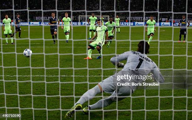 Sergio Aguero of Manchester City scores a penalty to his team's second goal against goalkeeper Yann Sommer of Borussia Monchengladbach during the...