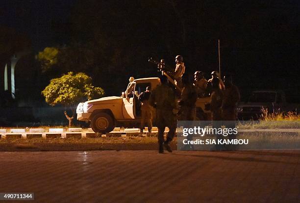 Soldiers of Burkina Faso's loyalist troops patrol the Naba Koom II barracks, the base of the Presidential Security Regiment in Ouagadougou on...