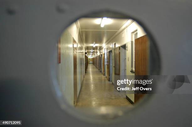 Looking through an eyehole on the door leading to the corridor holding the cell once occupied by Nelson Mandela during his 27-year incarceration as a...