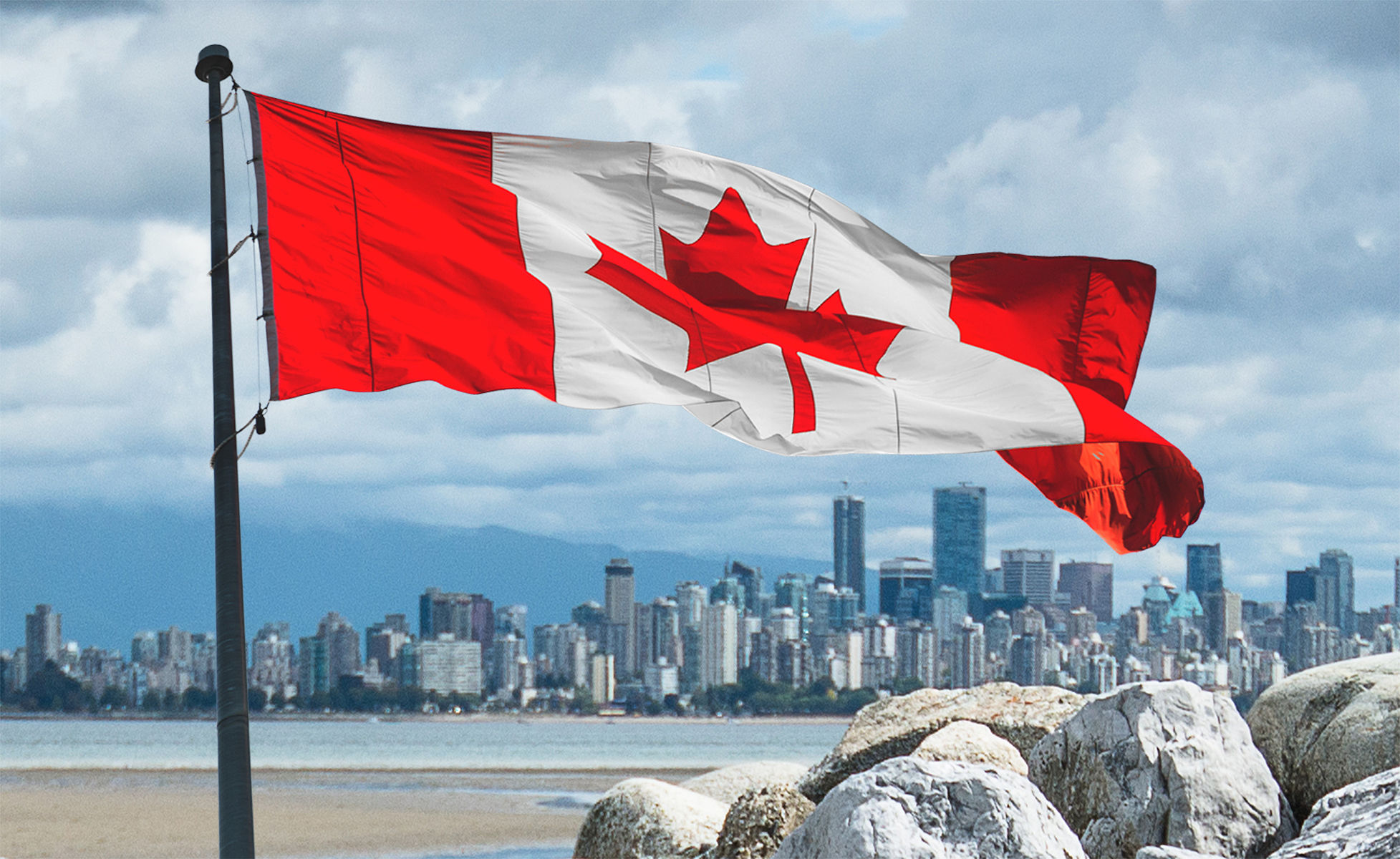 Vancouver skyline from the beach with canadian flag Vancouver skyline from the beach with canadian flag