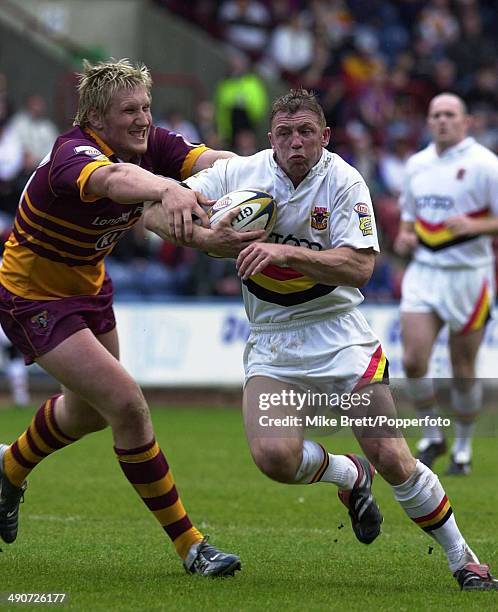 Bradford Bulls' Mike Forshaw tries to evade Eorl Crabtree of Huddersfield Giants during their Rugby Super League match held at the McAlpine Stadium,...