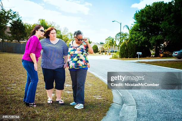 mature suburban american women watching and disapproving neighbours - judgement look stock pictures, royalty-free photos & images