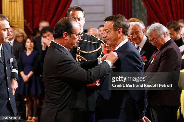 French President Francois Hollande gives to Director of sponsorship LVMH, Jean-Paul Claverie, Insignia of Officer of the Legion of Honor at Elysee...
