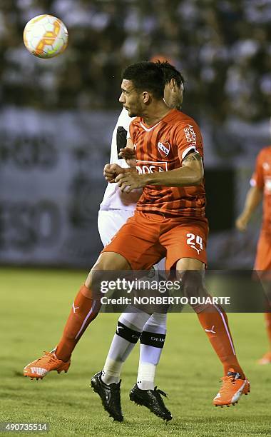 Julian Vitale of Argentina's Independiente vies for the ball with Miguel Paniagua of Paraguay's Olimpia during their Copa Sudamericana football match...