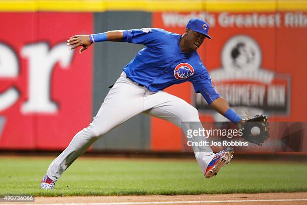 Jorge Soler of the Chicago Cubs is unable to catch a ball hit near the right field line by Brandon Phillips of the Cincinnati Reds in the first...