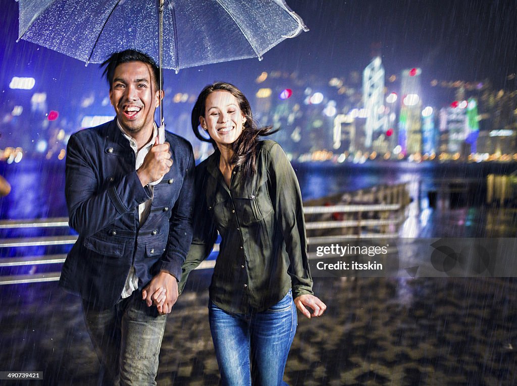 Multi-ethnic couple in Hong Kong under the rain