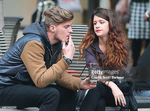 Man and a woman smoke cigarettes in the central business district on May 15, 2014 in Melbourne, Australia. Following a successful smoking ban in the...