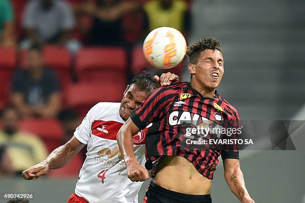 Indio of Brazil's Brasilia vies for the ball with Matheus Carneiro of Brazil's Atletico Paranaense, during their Sudamericana Cup football match at...