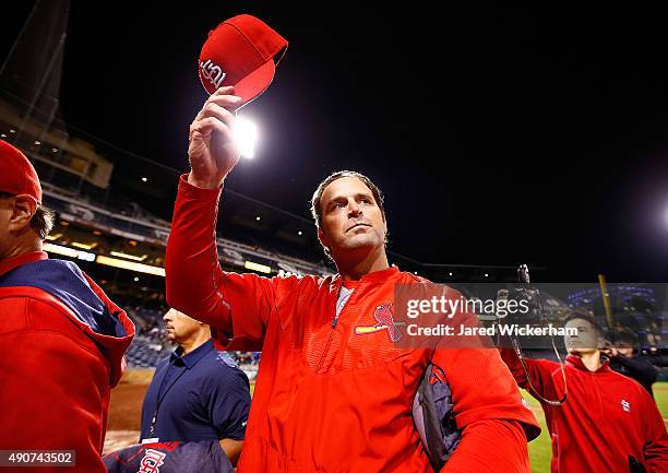 Manager Mike Matheny of the St Louis Cardinals tips his cap to the crowd following their 11-1 win against the Pittsburgh Pirates that clinched the...