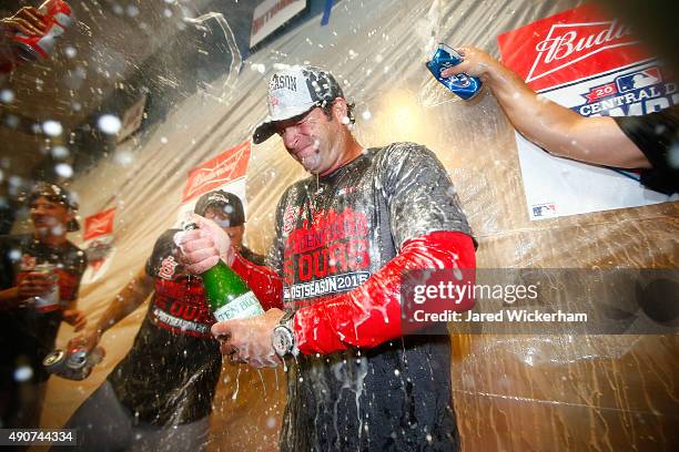 Manager Mike Matheny of the St Louis Cardinals celebrates with his players in the clubhouse following their division clinching 11-1 win against the...