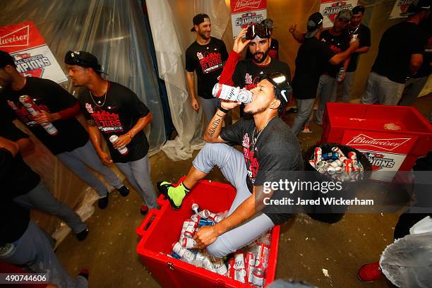 Carlos Martinez of the St Louis Cardinals celebrates with teammates in the clubhouse following their division clinching 11-1 win against the...