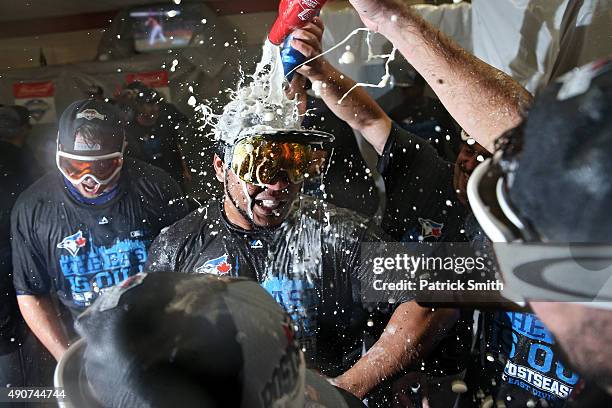 Edwin Encarnacion of the Toronto Blue Jays and teammates celebrate in the clubhouse after defeating the Baltimore Orioles and clinching the AL East...