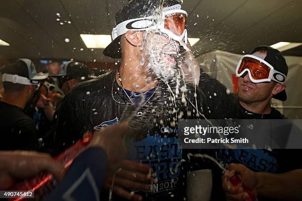 David Price and the Toronto Blue Jays celebrate in the clubhouse after defeating the Baltimore Orioles and clinching the AL East Division following...