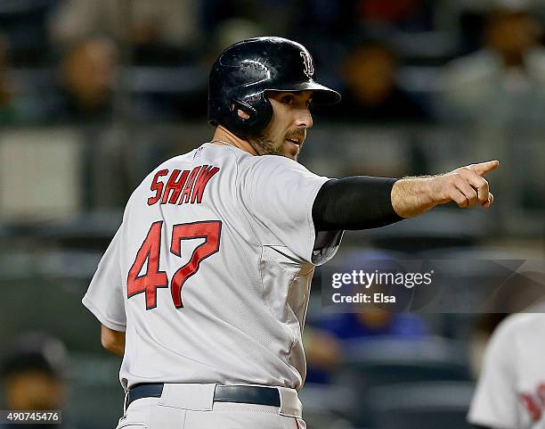 Travis Shaw of the Boston Red Sox scores the game winning run in the 11th inning against the New York Yankees off a hit by Deven Marrero of the...