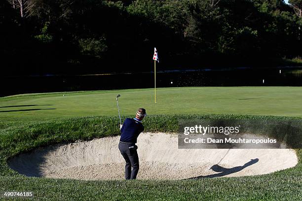 Raphael Jacquelin of France hits his second shot on the 11th hole out of the bunker during Day 1 of the Open de Espana held at PGA Catalunya Resort...