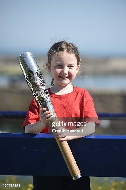 In this handout image provided by Glasgow 2014 Ltd, Grace Millan, aged 5, from St Anne's School, is the first Commonwealth Games Baton bearer on the...