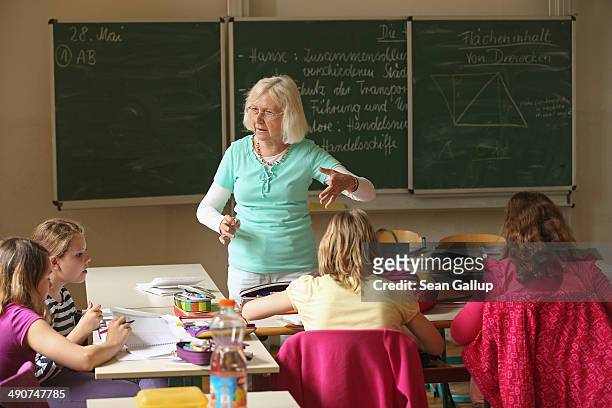 Retired teacher and volunteer Edith Preisert teaches a history class at the Middle School on May 14, 2014 in Seifhennersdorf, Germany. The state of...