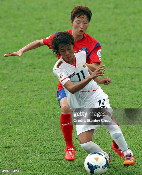 Khin Moe Wai of Myanmar is checked by Kim Hye Ri of Korea Republic during the AFC Women's Asian Cup Group B match between Korea Republic and Myanmar...