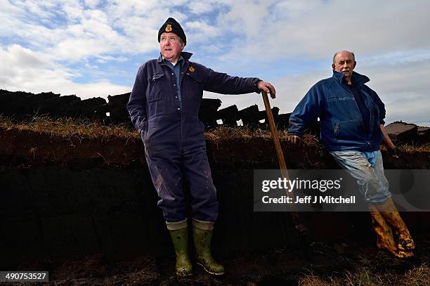 Dan Smith and Donald Campbell, extract peat from a moor near the village of Cross on May 14, 2014 in Lewis, Scotland. The tradition of peat cutting...