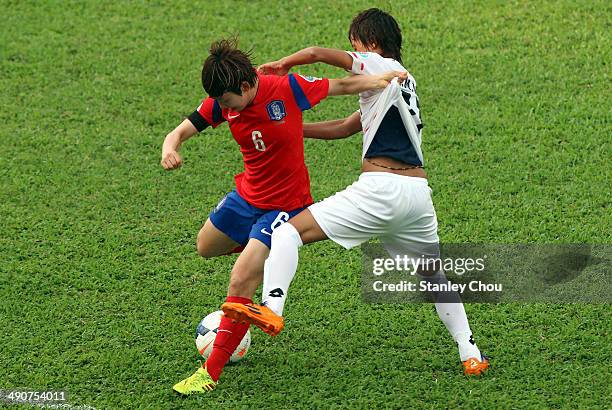 Lim Seon Joo of Korea Republic is challenged by Khin Moe Wai of Myanmar during the AFC Women's Asian Cup Group B match between Korea Republic and...