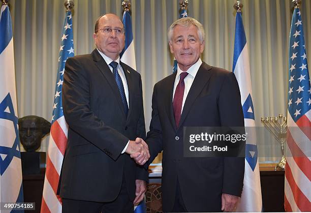 Israeli Defense Minister Moshe Ya'alon poses with US Defense Secretary Chuck Hagel before a bilateral meeting at The Kirya, the Israeli Defense Force...