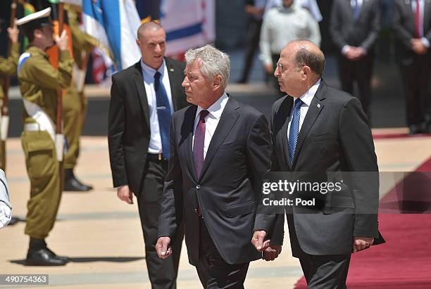 Israeli Defense Minister Moshe Ya'alon escorts US Defense Secretary Chuck Hagel past the honor guard upon the latter's arrival at The Kirya, the...