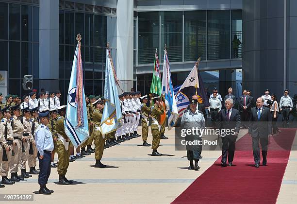 Israeli Defense Minister Moshe Ya'alon escorts US Defense Secretary Chuck Hagel past the honor guard upon the latter's arrival at The Kirya, the...