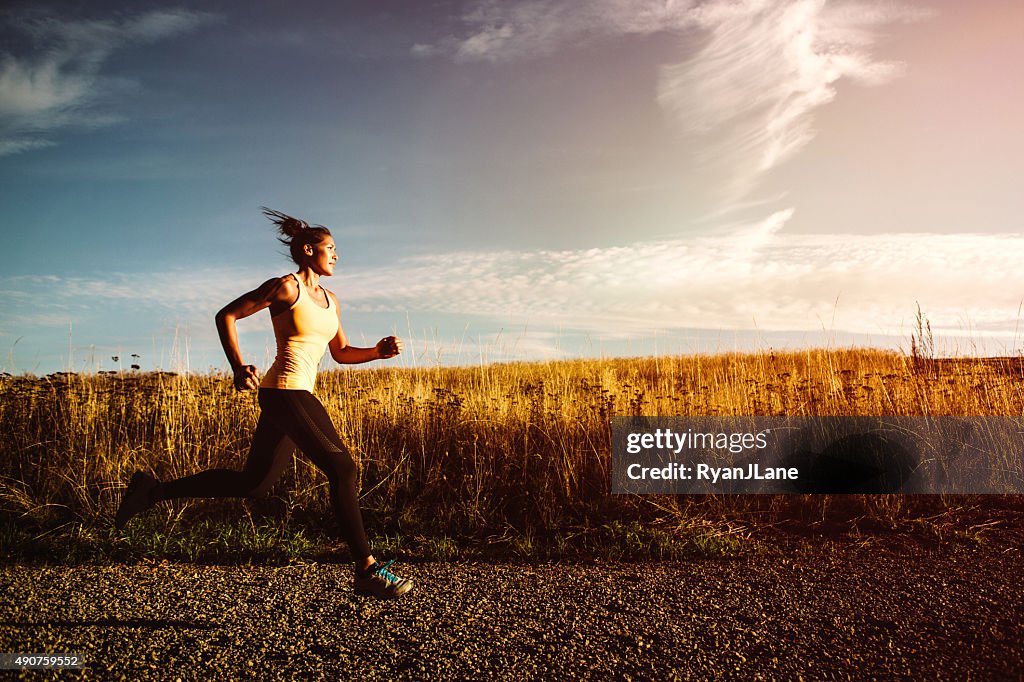 Woman Sprinting on Beautiful Sunset Road